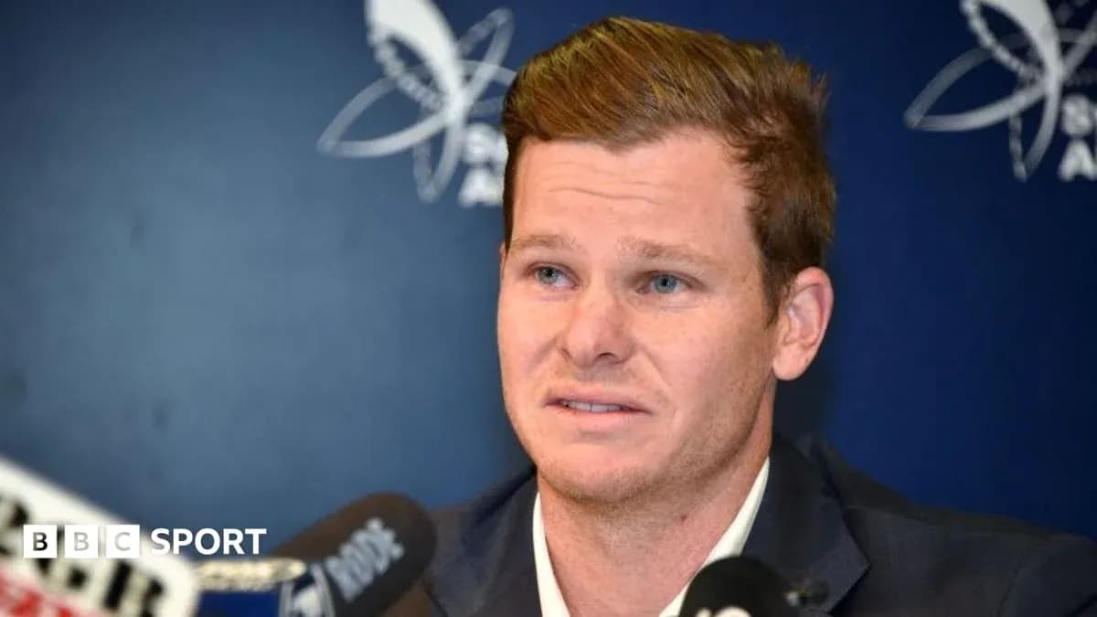 Cricketer speaking at press conference with microphones