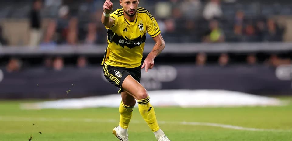 Player in yellow jersey signaling during match