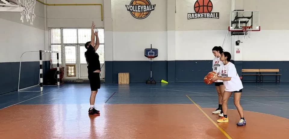 Coach instructing players during basketball practice session