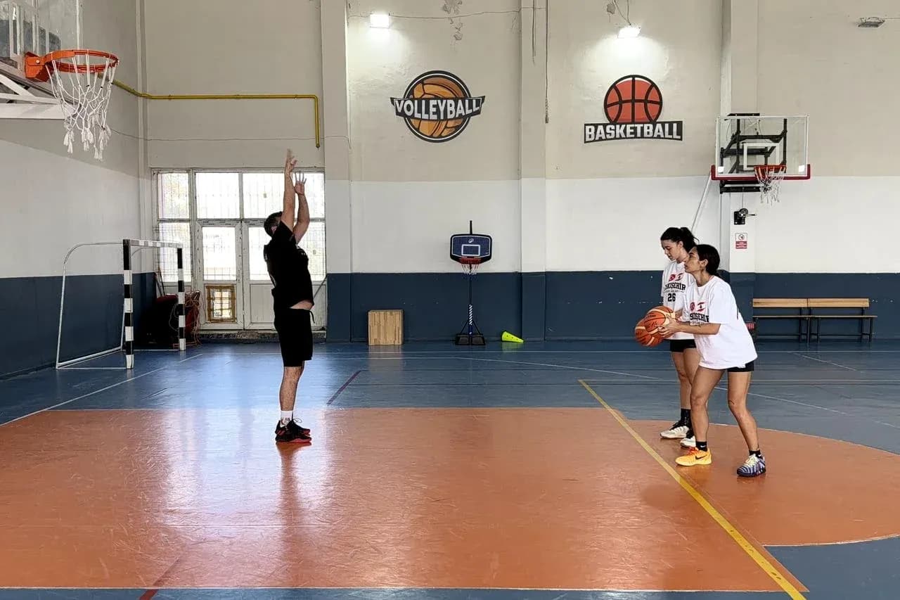 Coach instructing players during basketball practice session