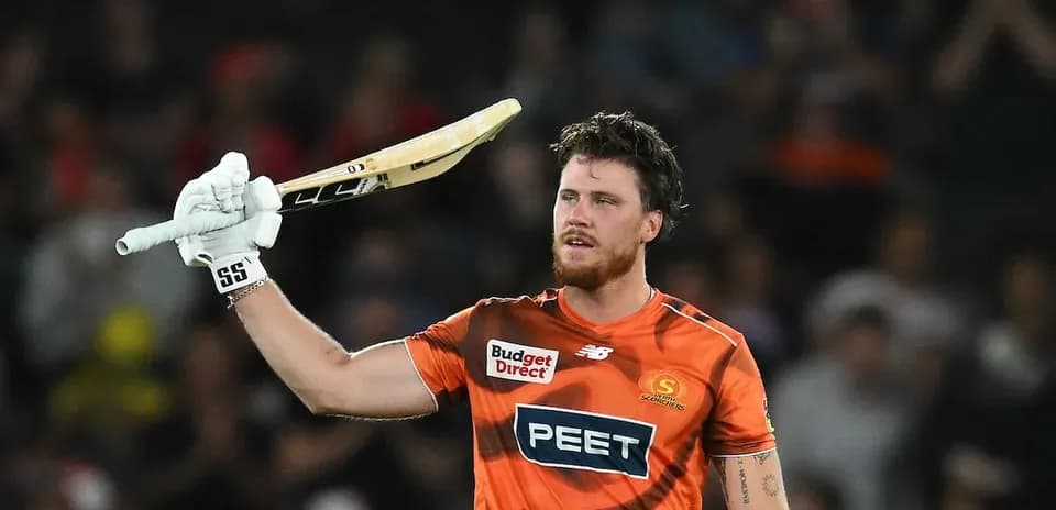 Batsman celebrating with raised bat after scoring