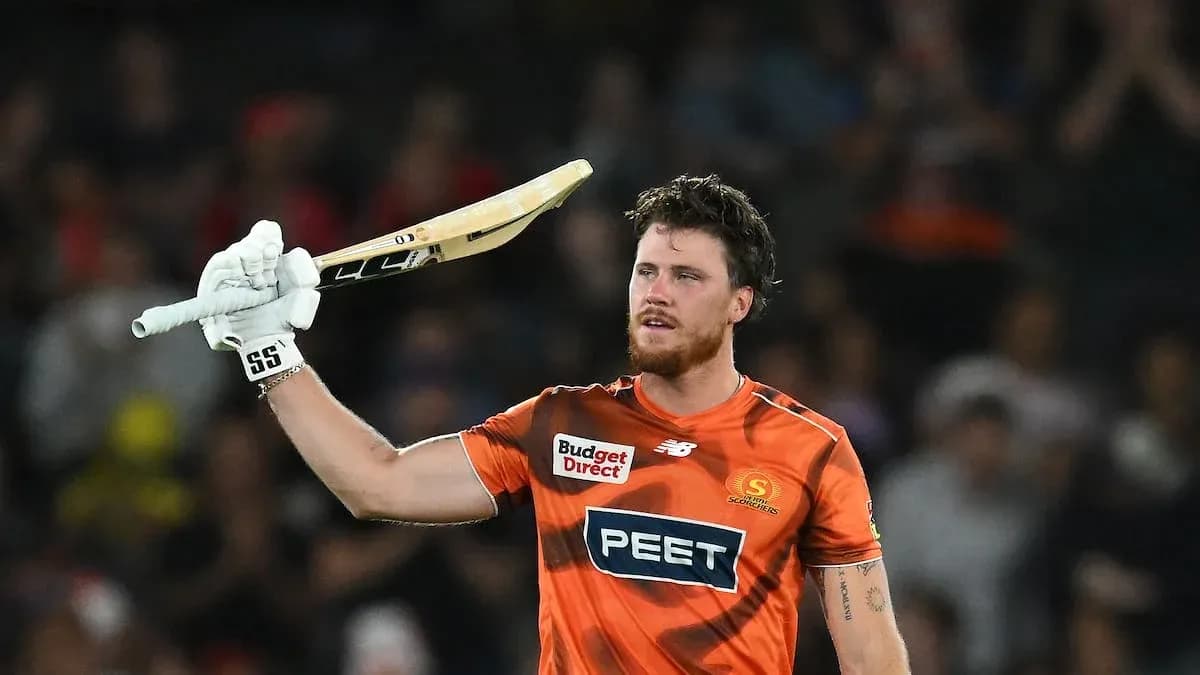 Batsman celebrating with raised bat after scoring
