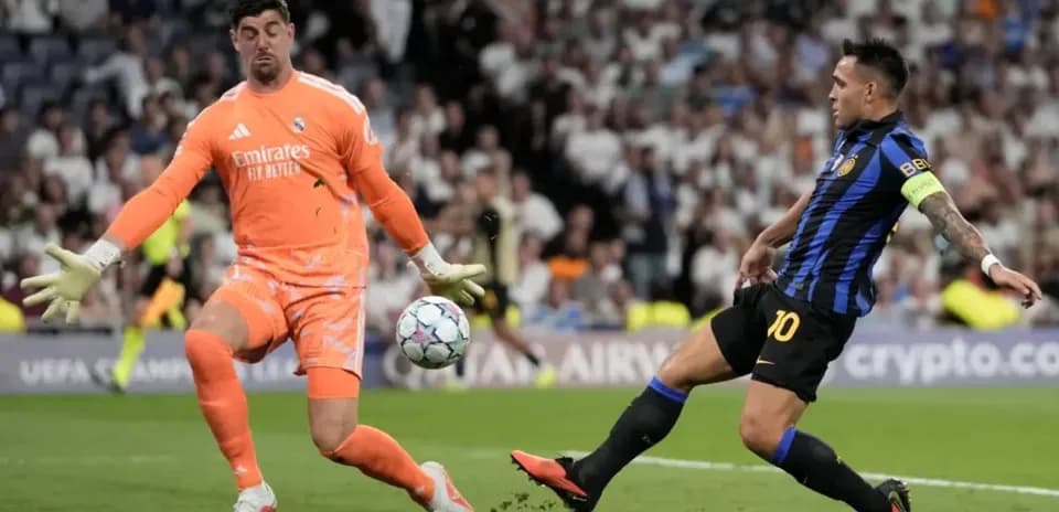 Goalkeeper and player contesting the ball during match