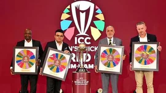 Four officials holding framed artwork at ICC event