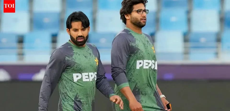Two Pakistan cricket players walking on field