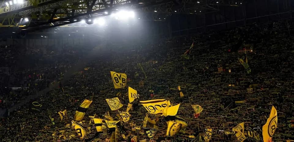 Borussia Dortmund fans waving flags in stadium