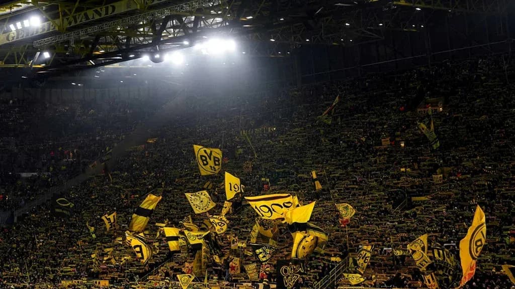 Borussia Dortmund fans waving flags in stadium