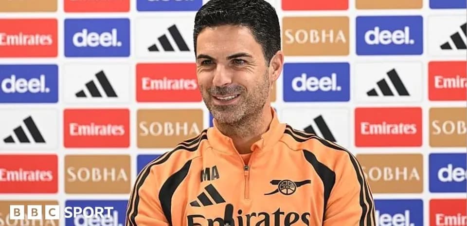 Manager speaking at press conference with backdrop