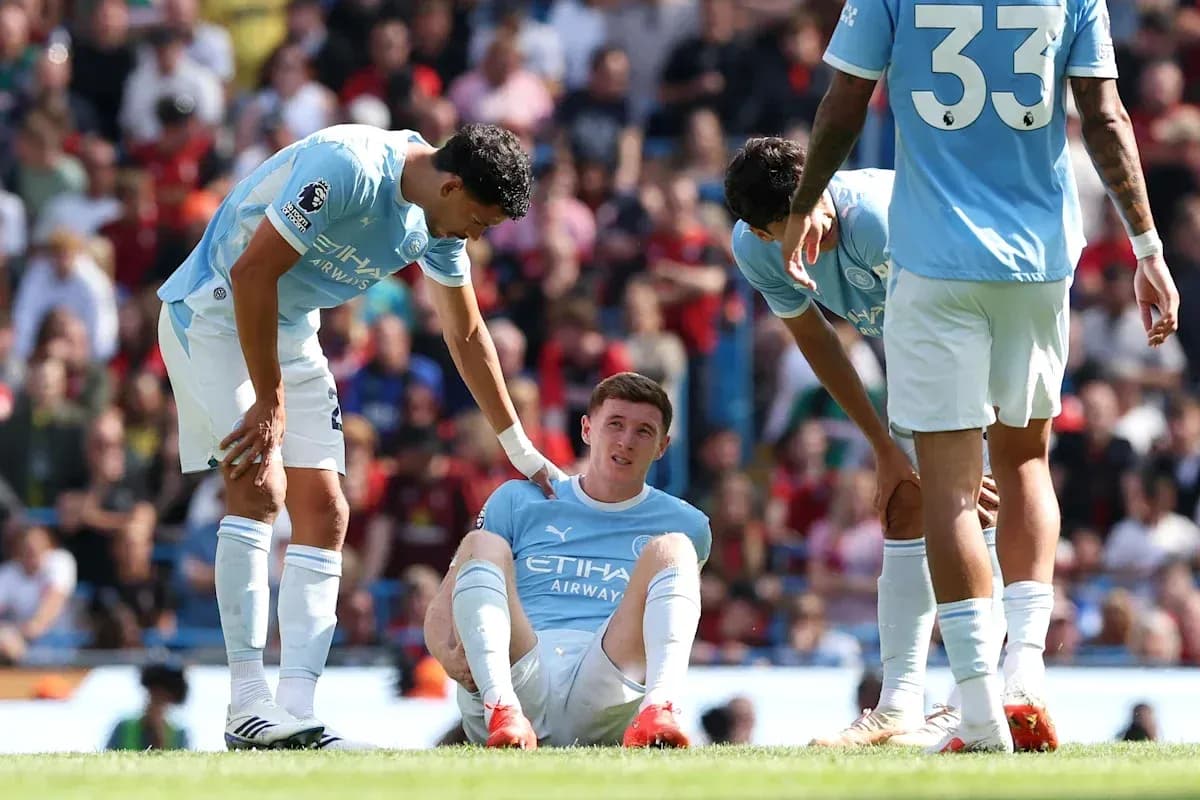 Player sitting on the ground, teammates offering support