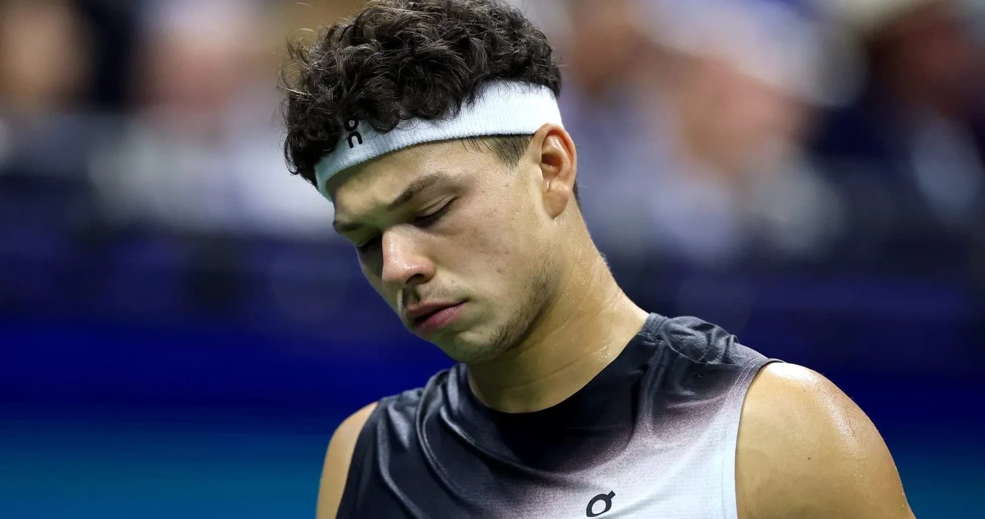 Tennis player looking down during match