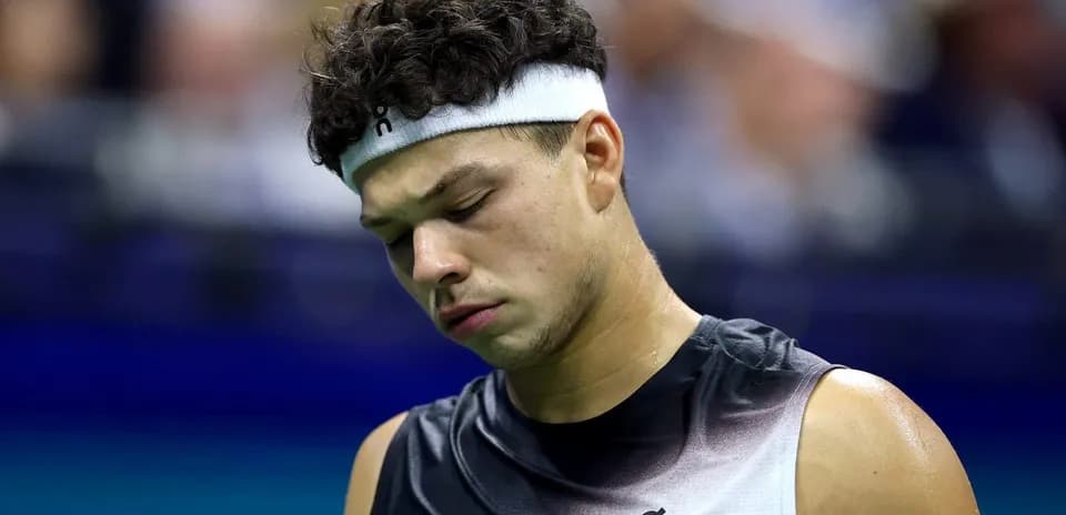 Tennis player looking down during match