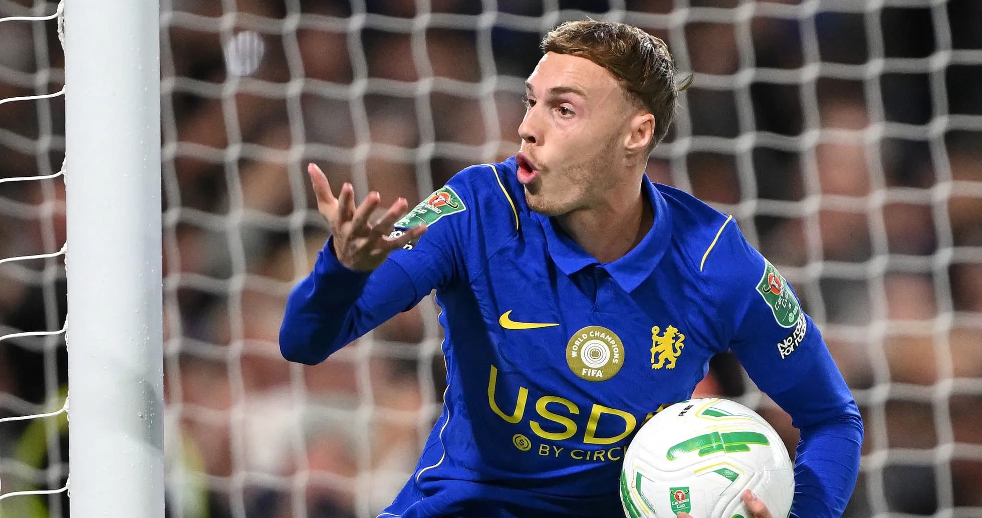 Player gesturing while holding the ball in goal