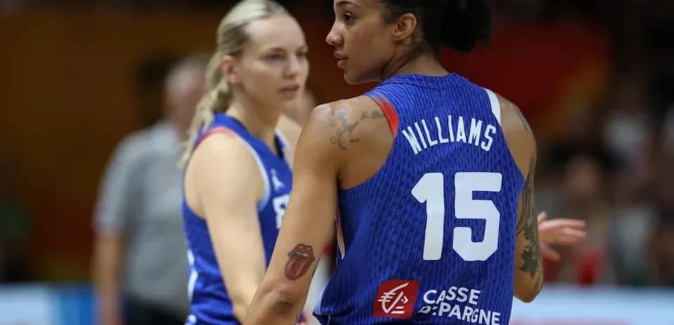 Two basketball players on the court during game