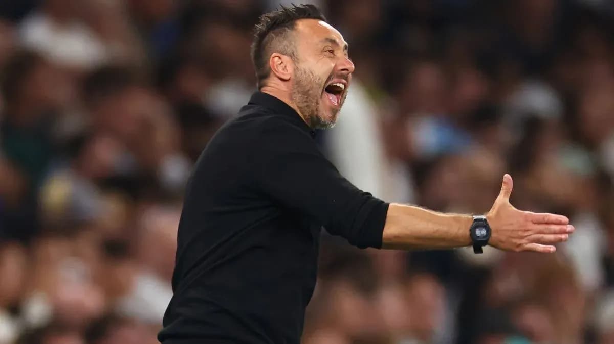 Coach gesturing passionately during a match