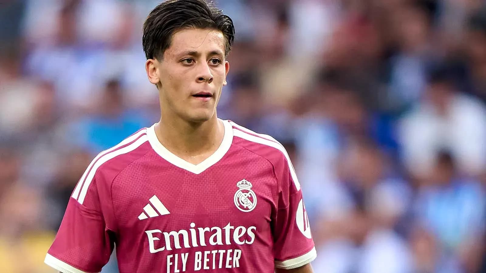 Player wearing pink Real Madrid jersey on field