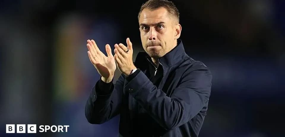 Coach applauding from the sidelines during match
