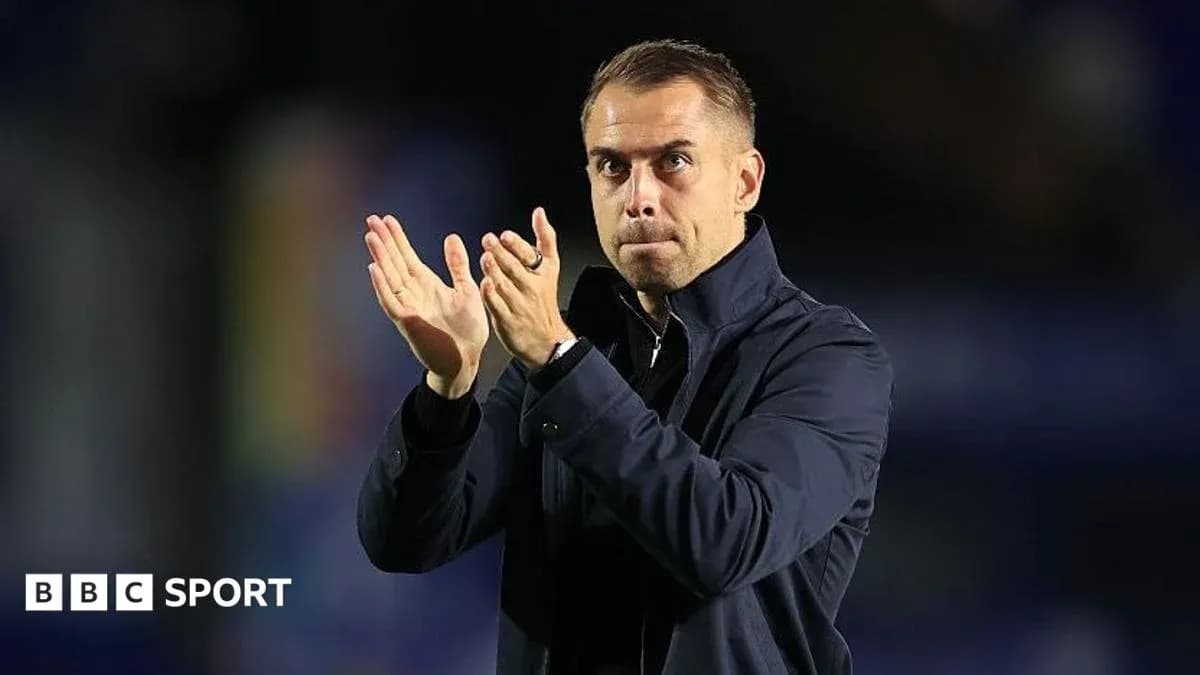 Coach applauding from the sidelines during match