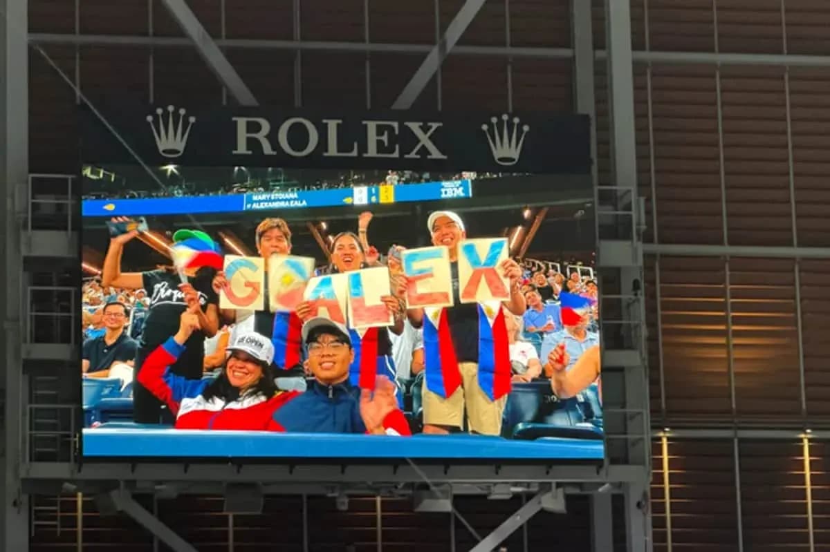 Fans cheering with signs in stadium stands