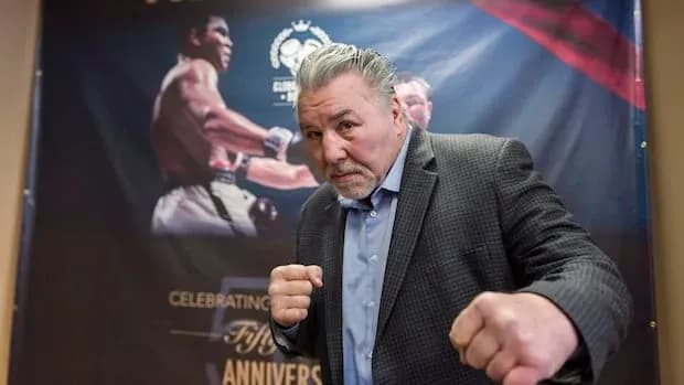Former boxer posing with fists raised at event