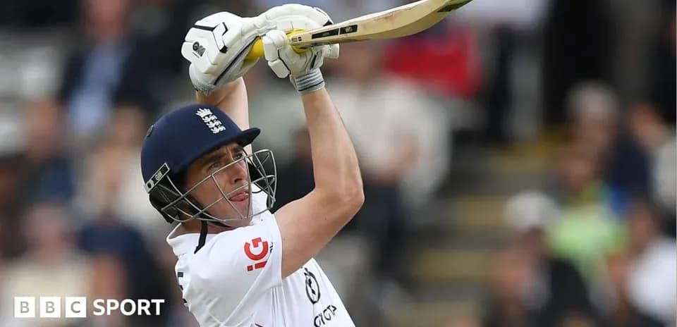 Cricketer batting with raised bat in stadium