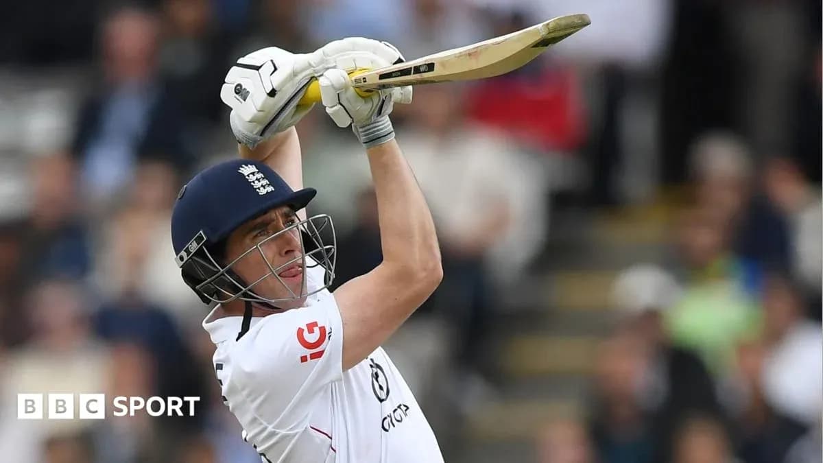 Cricketer batting with raised bat in stadium