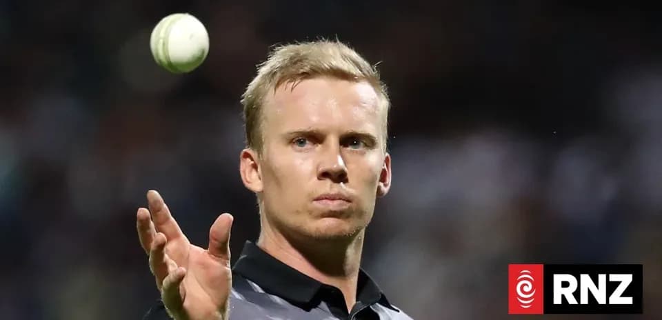 Cricket player throwing ball during match