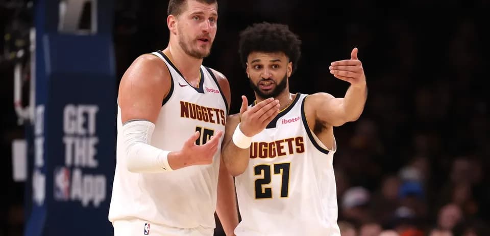 Two Denver Nuggets players discussing during a game