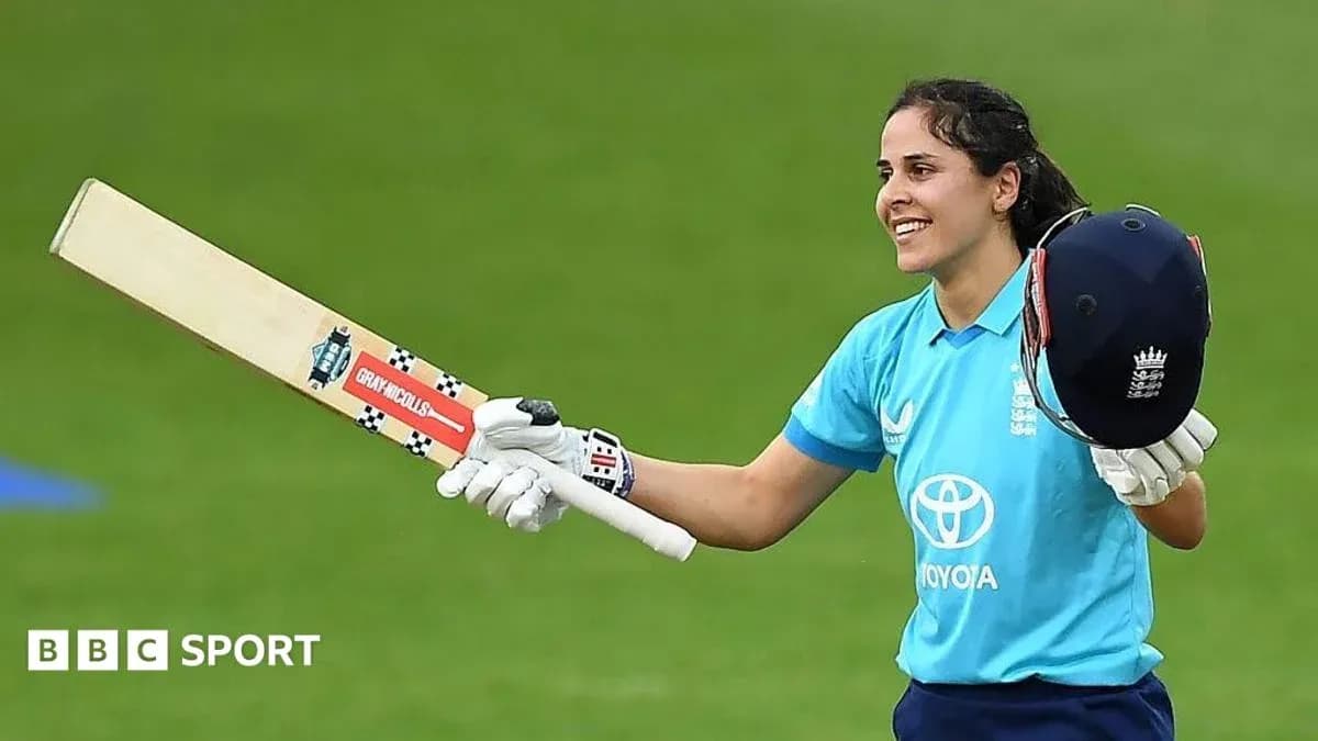 Cricketer celebrating with bat and helmet raised