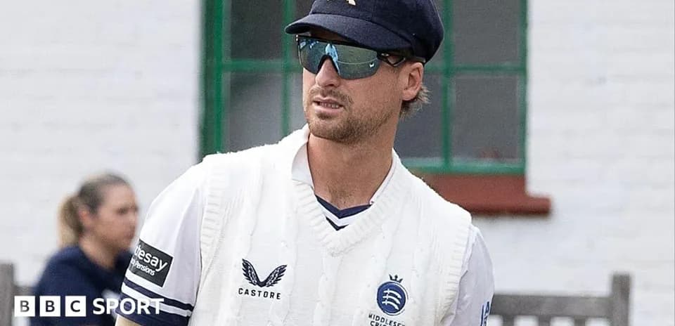 Cricketer wearing Middlesex kit and sunglasses
