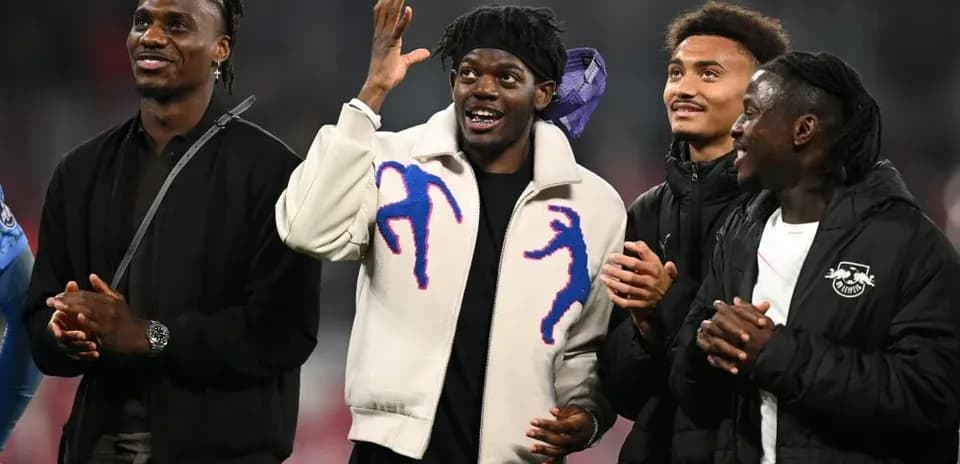 Four football players interacting and smiling together