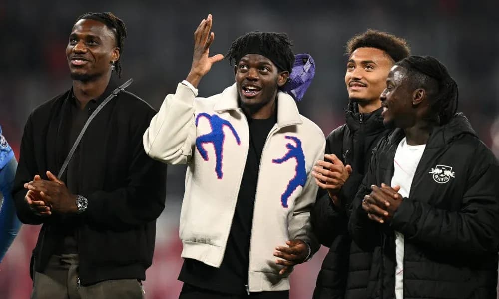 Four football players interacting and smiling together