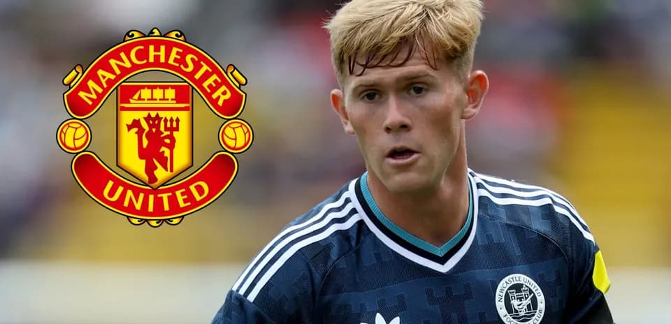 Player wearing Newcastle United kit near Manchester United logo