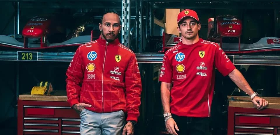 Two drivers in Ferrari team uniforms posing together