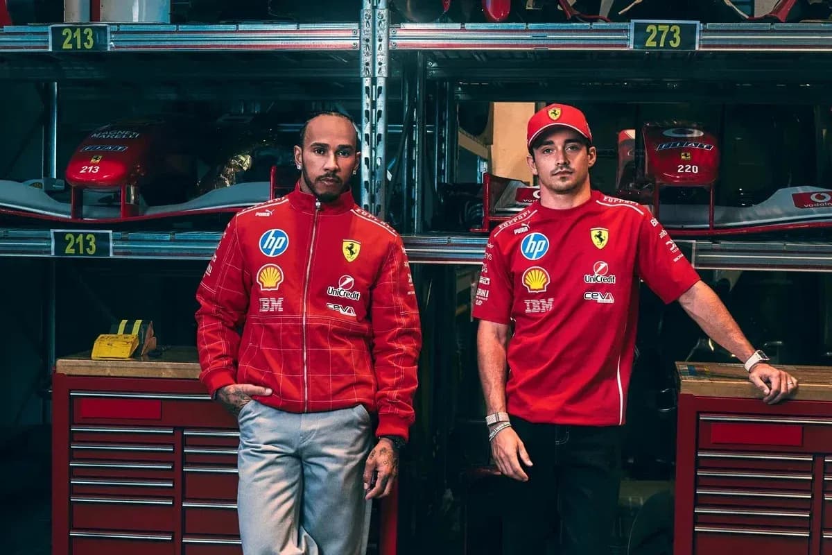 Two drivers in Ferrari team uniforms posing together
