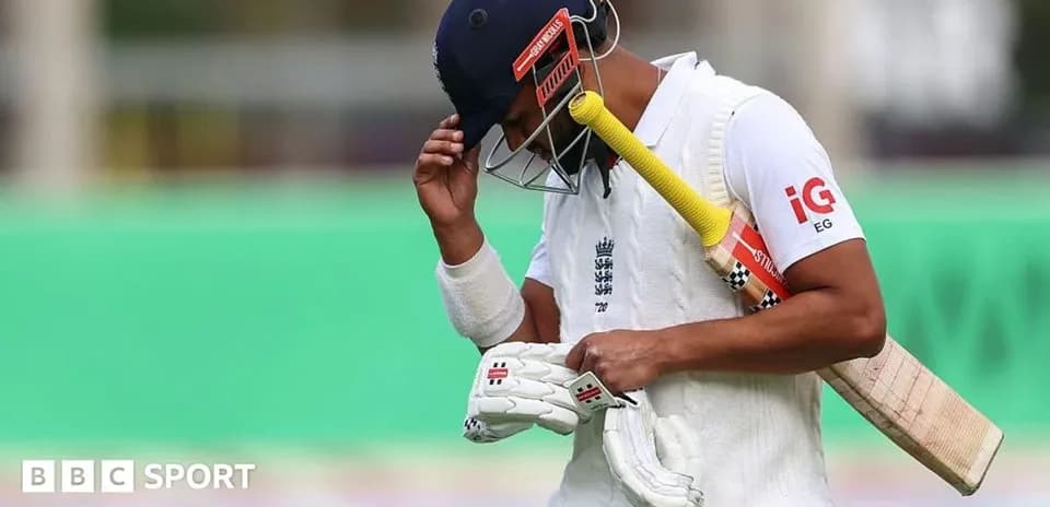 Cricketer walking off field after dismissal
