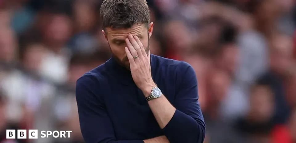 Manager covering face in frustration during match
