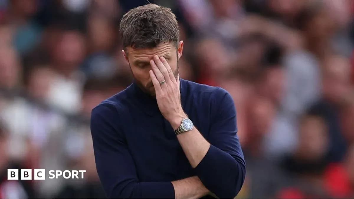 Manager covering face in frustration during match