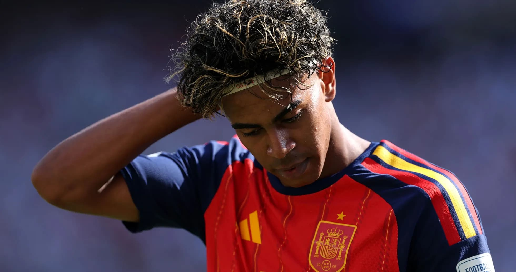 Player wearing Spain jersey looking down during match