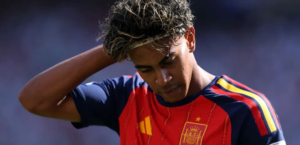 Player wearing Spain jersey looking down during match