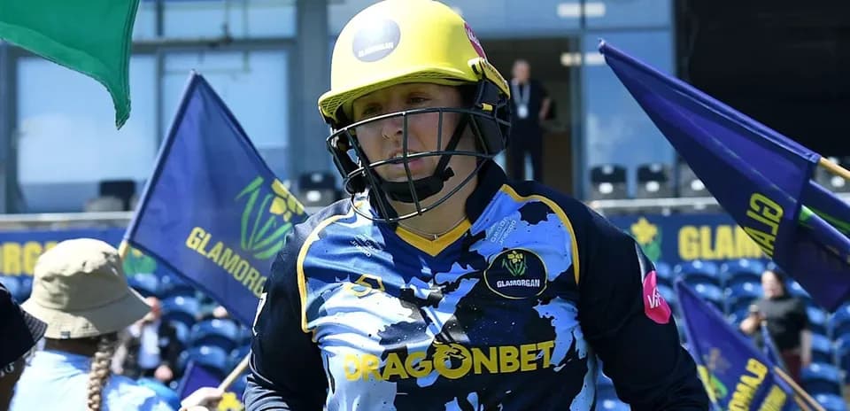 Player from Glamorgan entering the field with flags