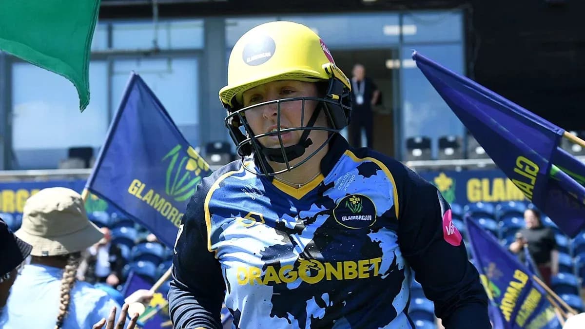 Player from Glamorgan entering the field with flags