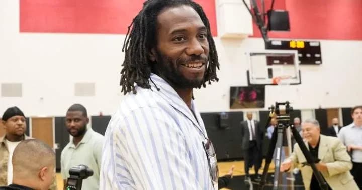Man smiling at event with people in background
