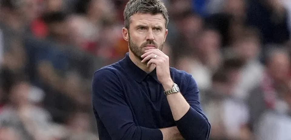 Manager observing the match with thoughtful expression