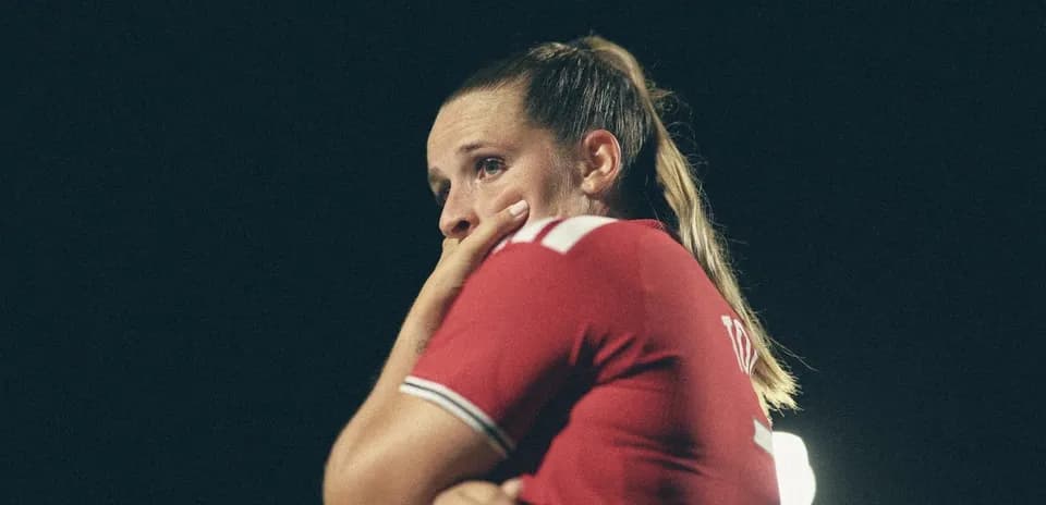 Player in red jersey looking concerned during match