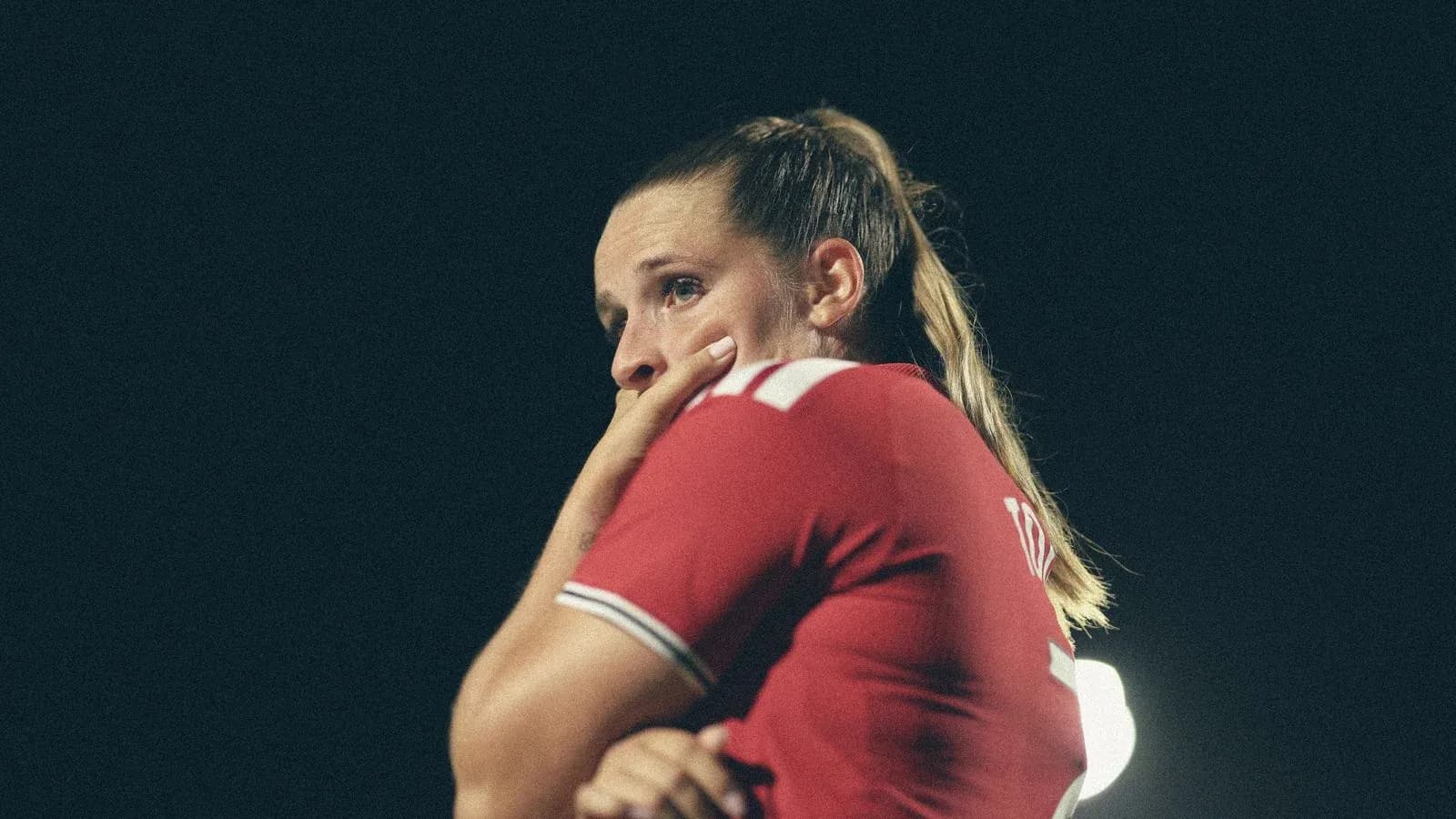 Player in red jersey looking concerned during match