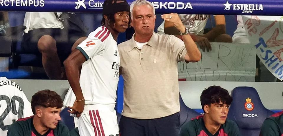 Coach giving instructions to player on bench