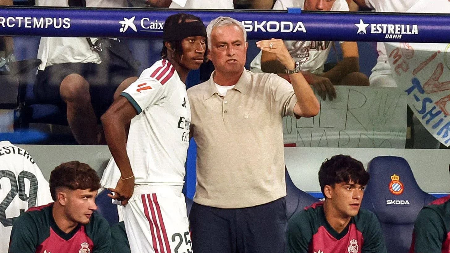 Coach giving instructions to player on bench