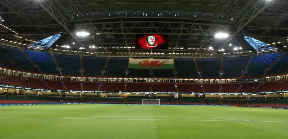 Empty stadium with Welsh flag and logo displayed