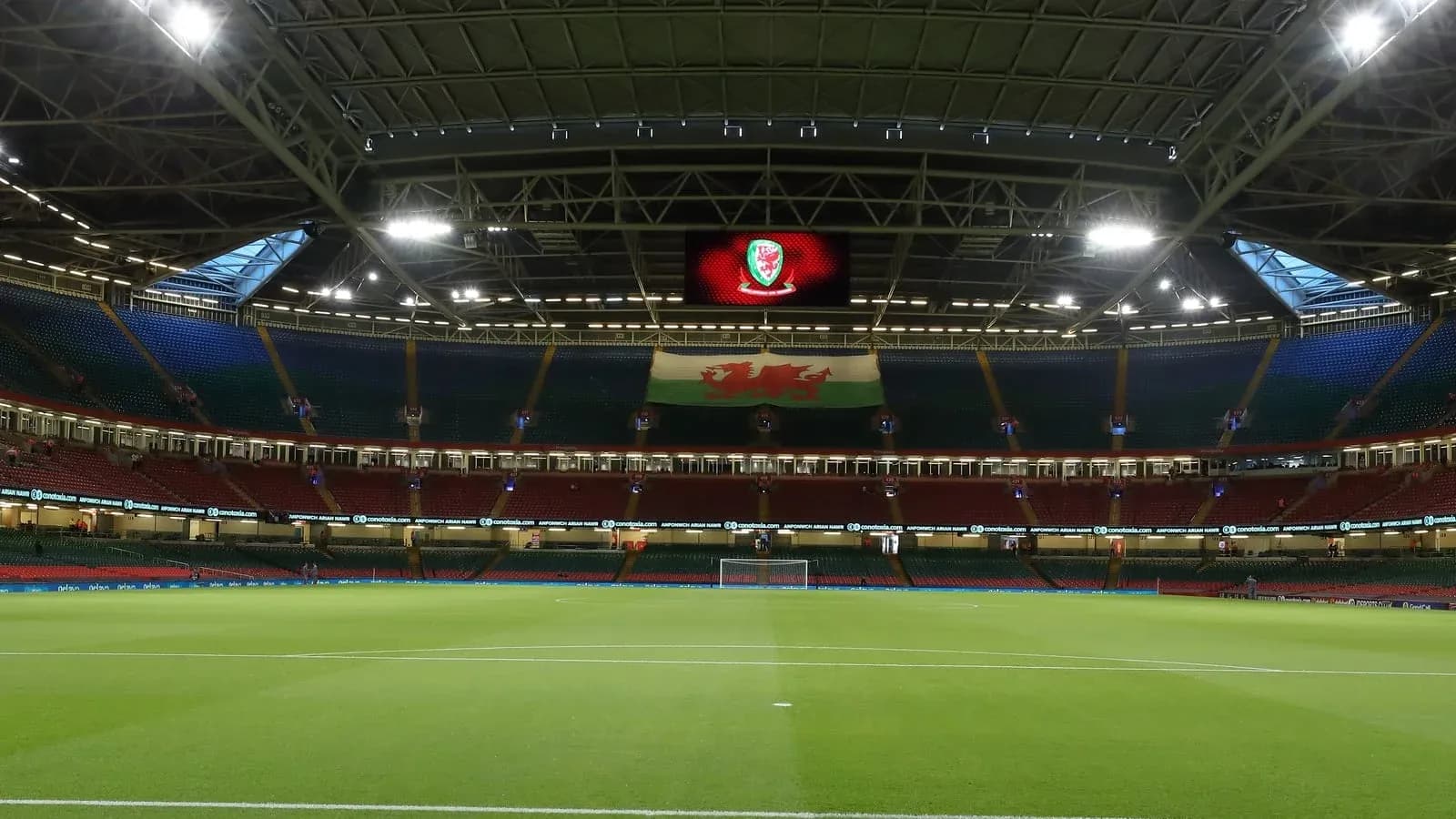 Empty stadium with Welsh flag and logo displayed