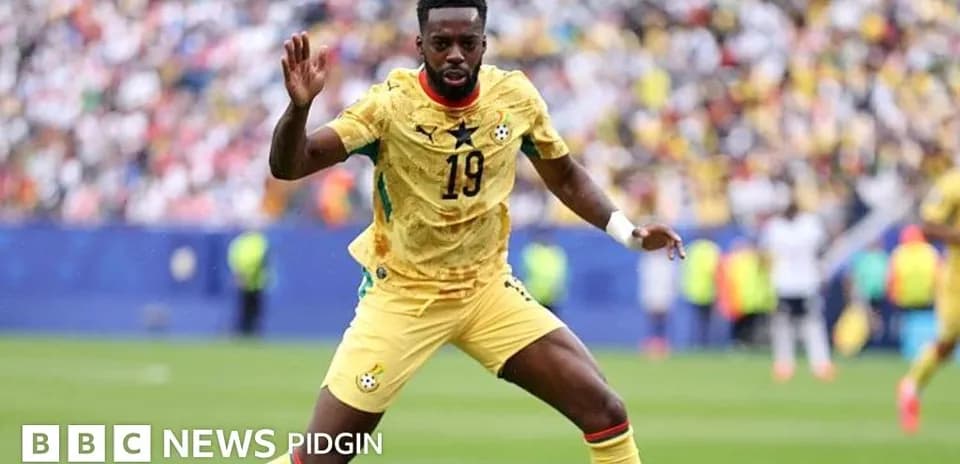 Ghana player in yellow jersey during match action